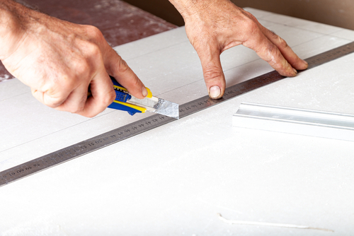 Use a utility knife to score the paint and joint compound